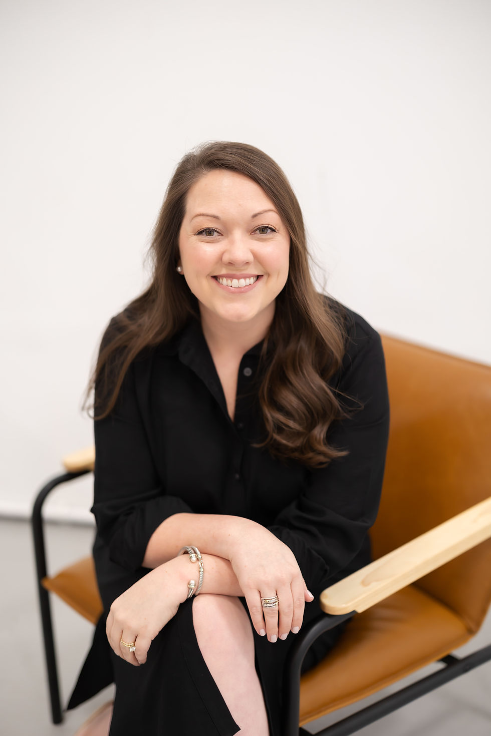 Professional providing personal notary services smiling in a chair