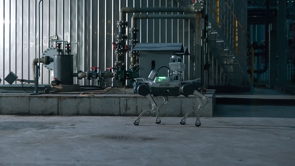 Robotic dog walking in a metallic industrial corridor with overhead lights and coiled cables along the wall, creating a futuristic mood.