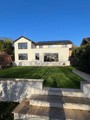 Double-storey new build and extension in Surrey featuring two first-floor extensions, new driveway, patio, and landscaped gar