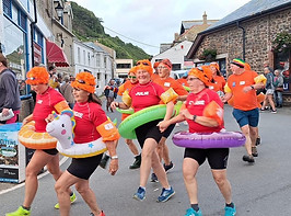 Looe Sea Swimming Group from East Looe Beach, Looe, Cornwall, taking part in the annual Looe Carnival event.