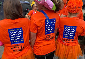 Looe Sea Swimmers from East Looe Beach, Looe, Cornwall, taking part in the annual Looe Carnival event.