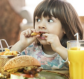 little-girl-eats-fast-food-cafe.jpg