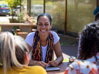 Group of women outside supporting each other during training
