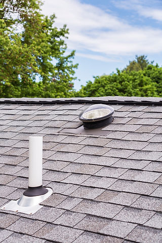 New Shingle roof with a small skylight and a venting stack to help keep the house energy efficient