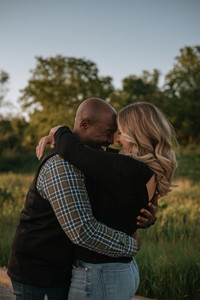 a spring engagement session for a newly engaged couple as they sway in the breeze