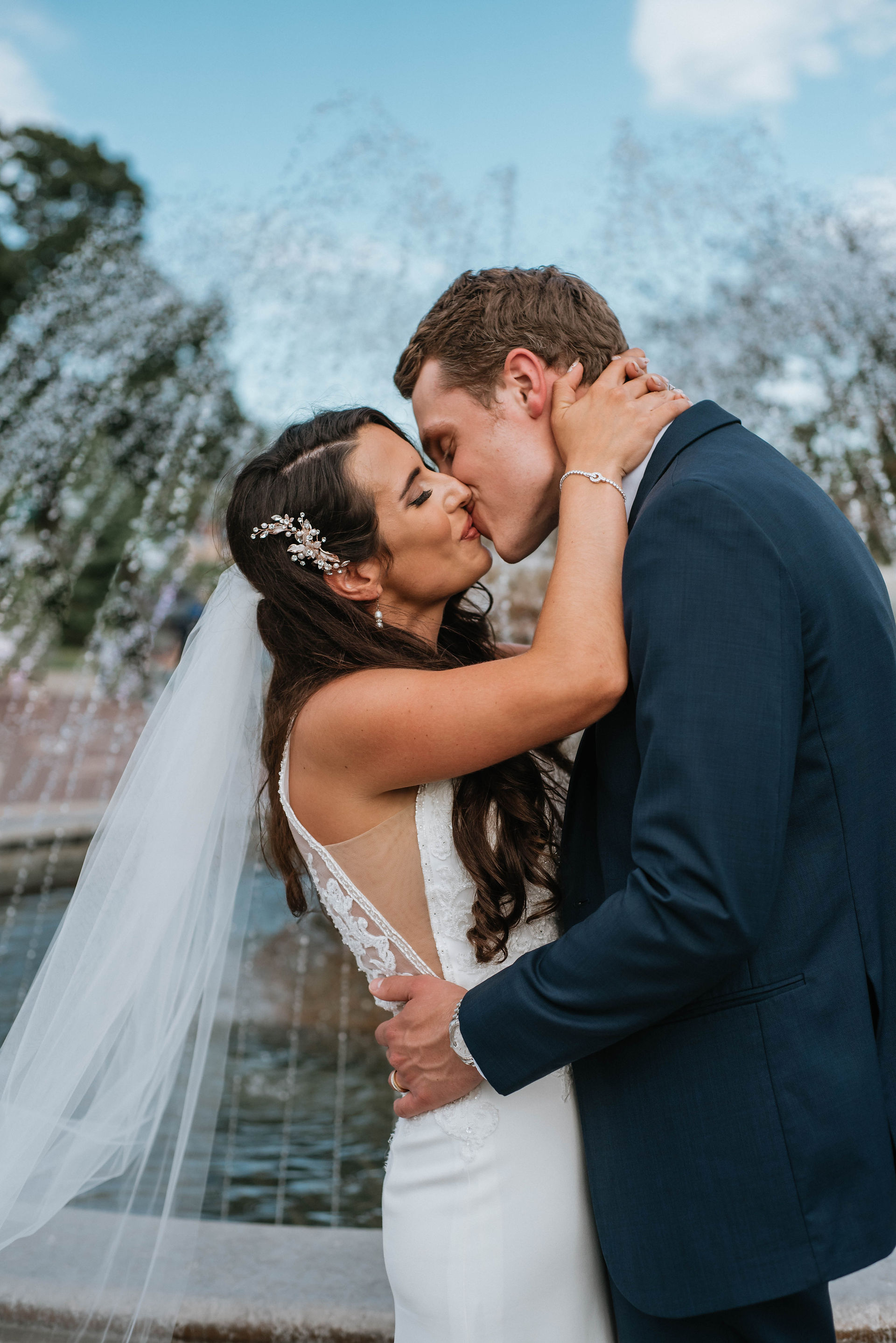 a kiss is shared in front of the fountain at Riviera ballroom lake geneva wisconsin