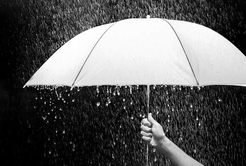 Hand holding an umbrella in rain, black