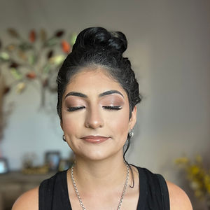 a woman with close eyes wearing full face natural glam makeup in Ave Maria