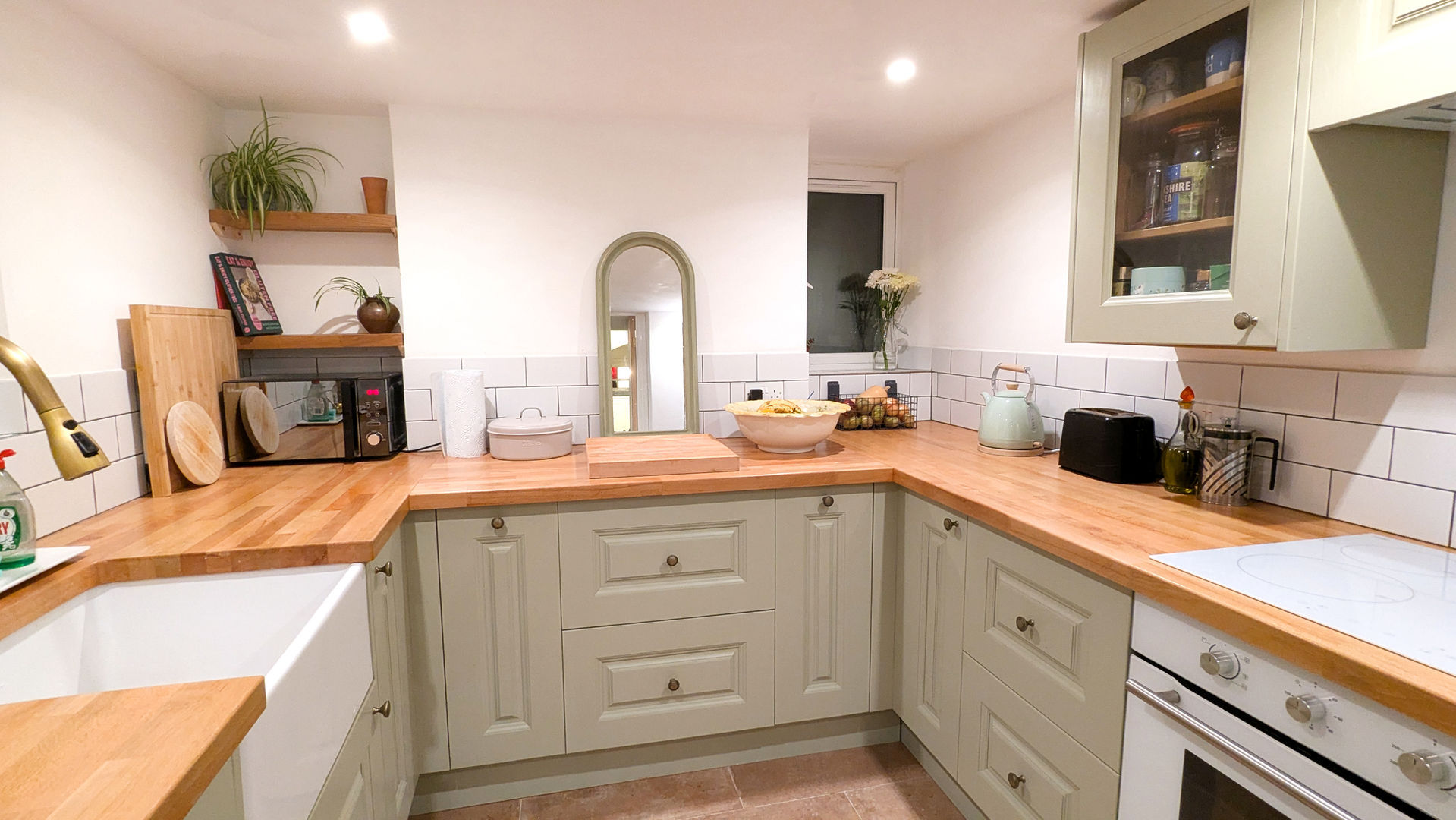 Beautiful kitchen renovation in sage green combining traditional and modern aesthetics 