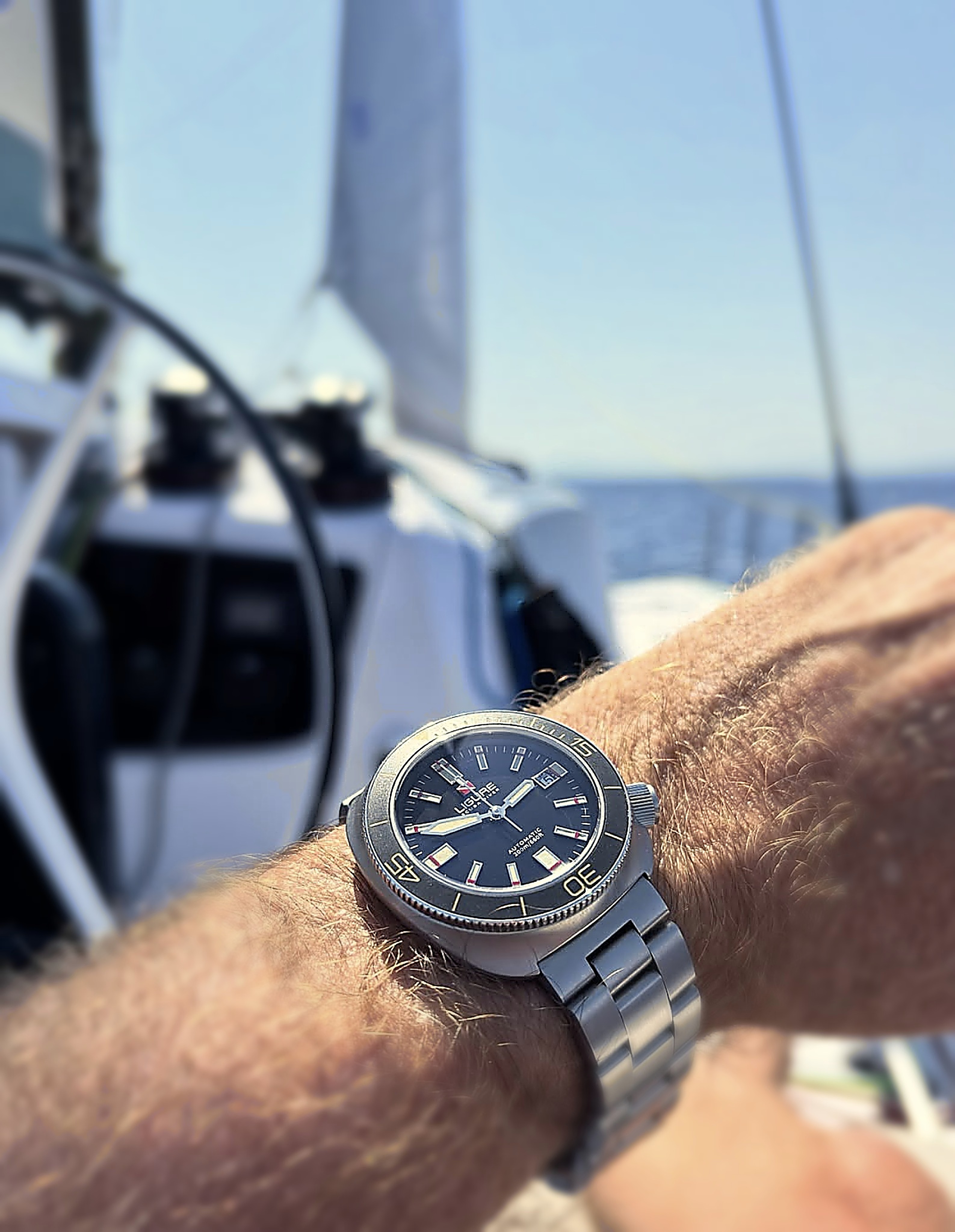 ligure watch in hand of a person in a boat