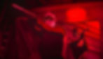 Sam Fisher and Zinnia McKenna in a red wash light, brandishing firearms in 'Splinter Cell: Deathwatch'