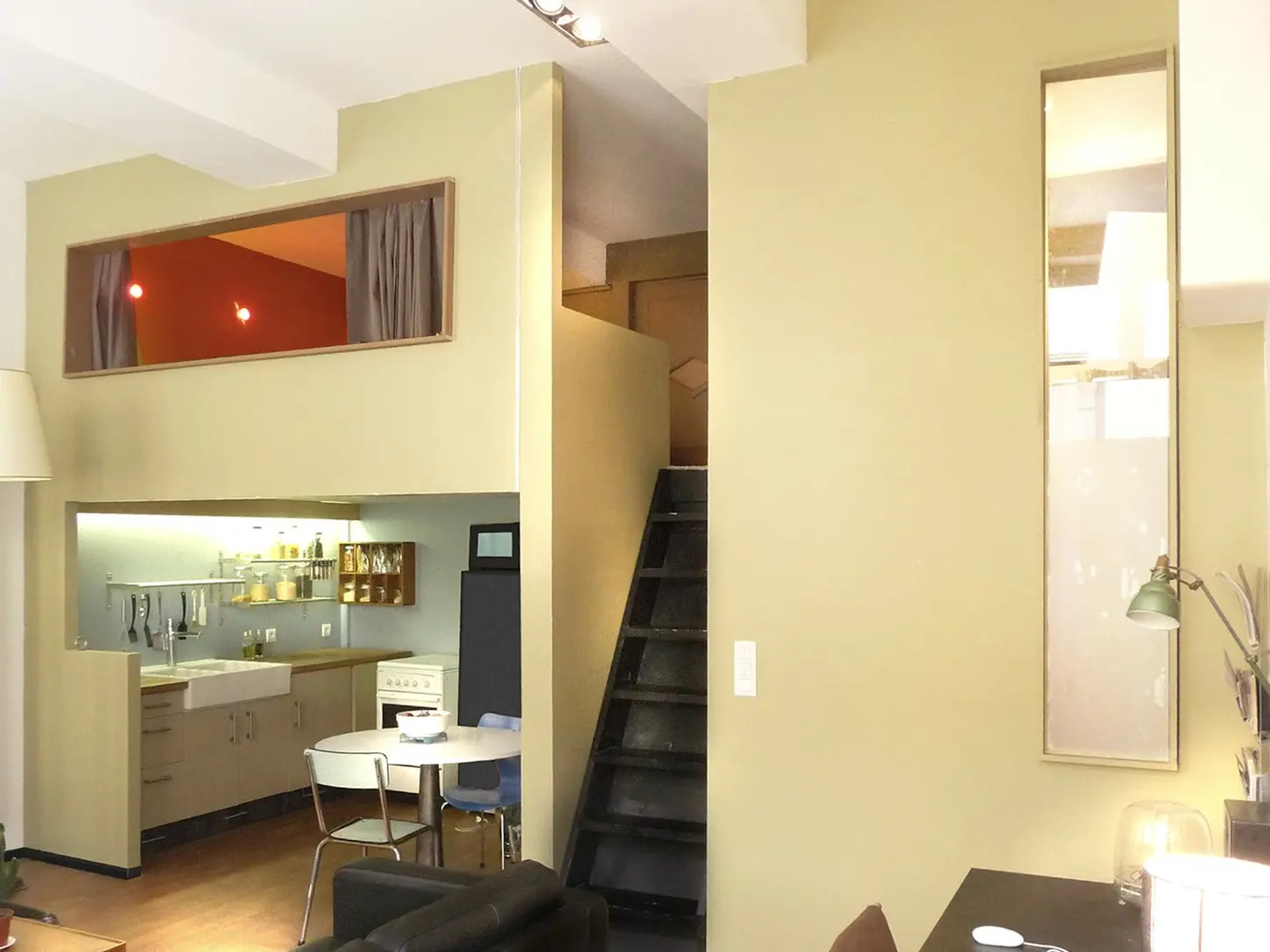Appartement rénové avec mezzanine, escalier noir et cuisine ouverte sur mesure dans le quartier Croix-Rousse à Lyon