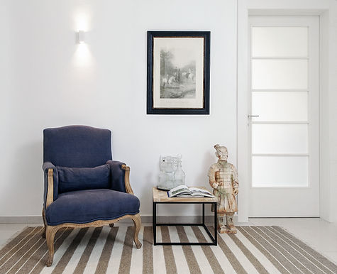 Repairs and Restorations of beautiful indoor house styled with rug and chair after work completed by plasterer in Auckland
