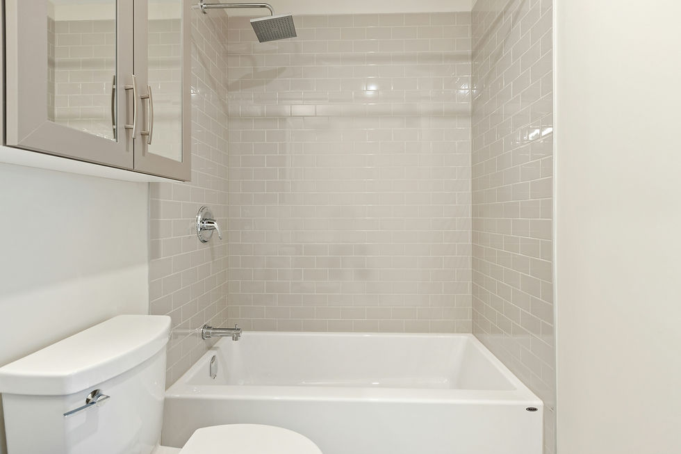 Modern bathroom with a white bathtub. Clean, minimalist design.