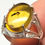 Thumbnail: Silver ring with Amber cabochon with insect inclusion held by two fingers