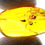 Thumbnail: Dominican amber with mosquito inclusion held between two fingers