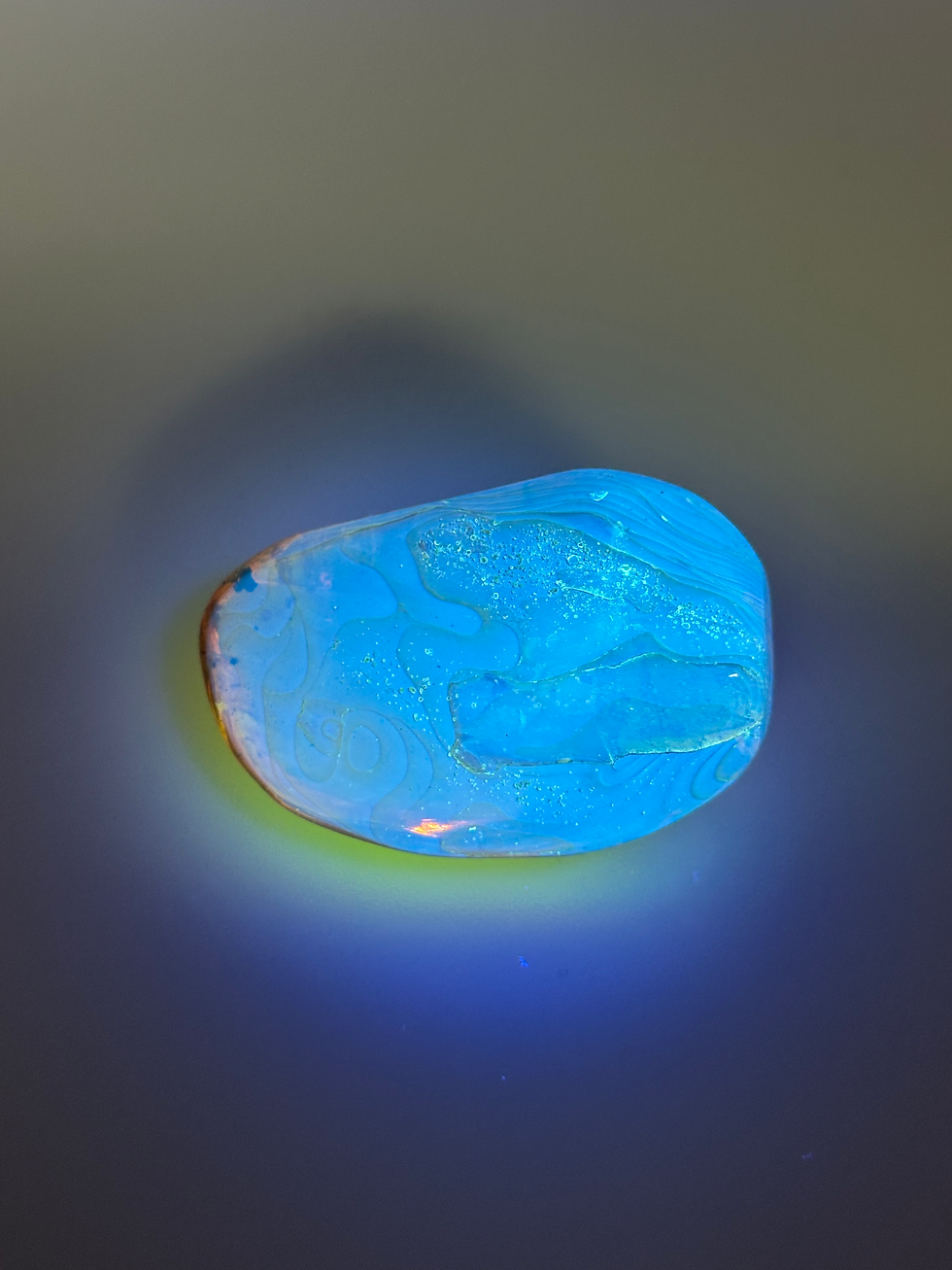 Thumbnail: dominican amber with leaf inclusion under uv light