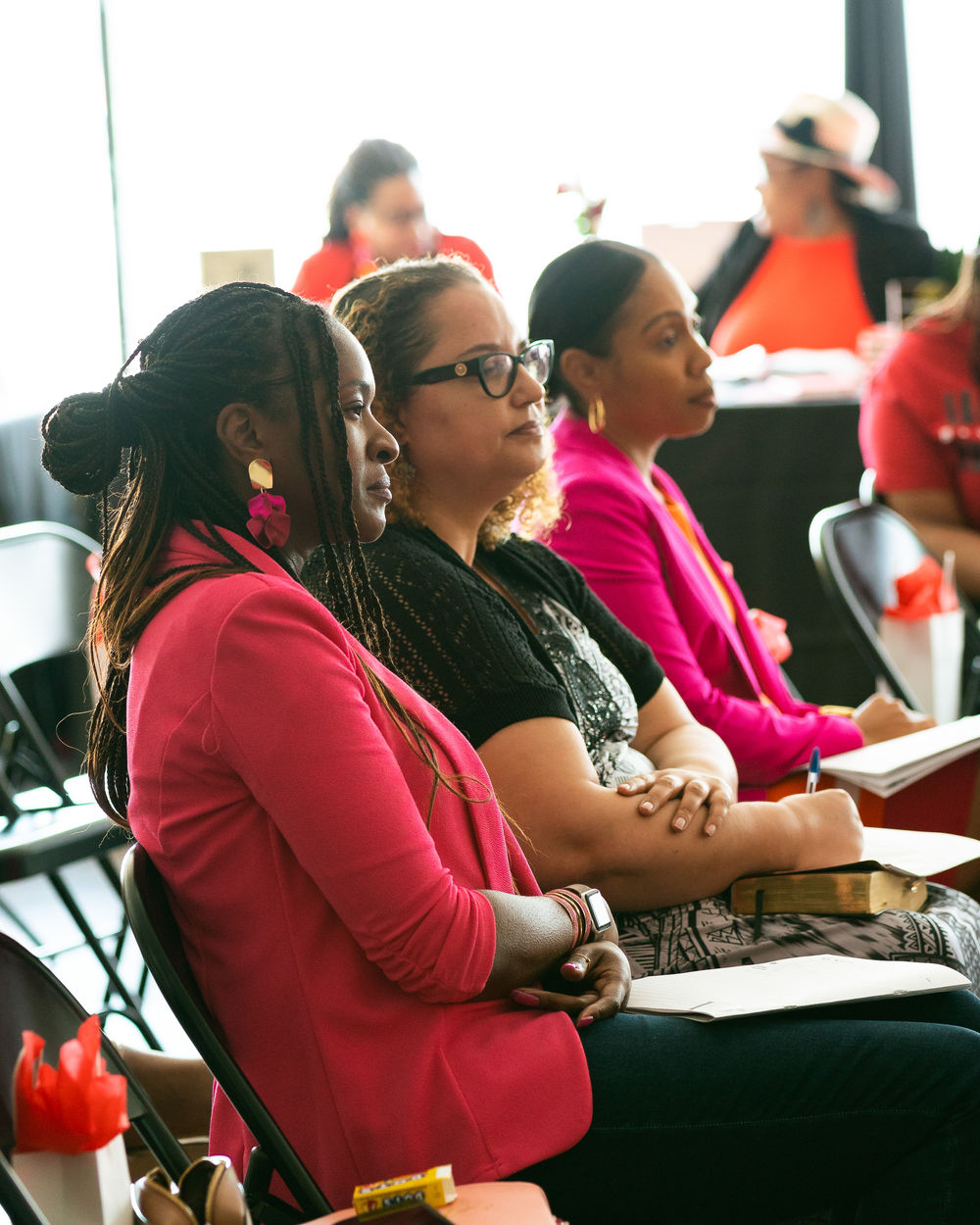Women seated together at a Fade2Bold gathering, listening