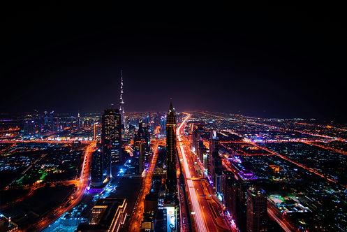 Night view of Dubai skyline, illuminated city lights and Burj Khalifa tower