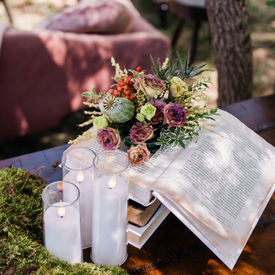 floral designer arranging flowers and greenery for custom event installation