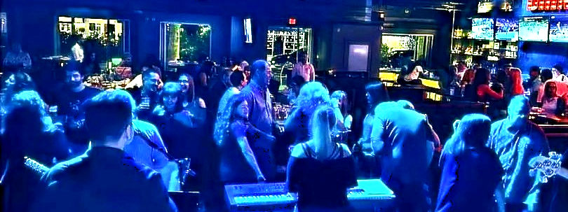 Exit Left performing live on stage in front of a large, energetic crowd during a behind-the-scenes moment