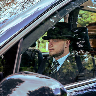 man driving a hearse