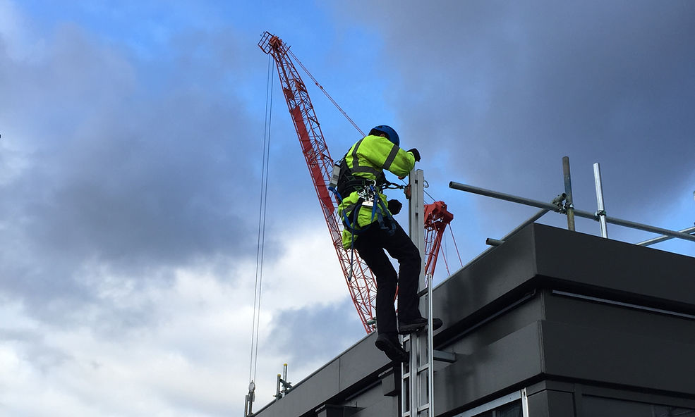 A man climbing a tall ladder