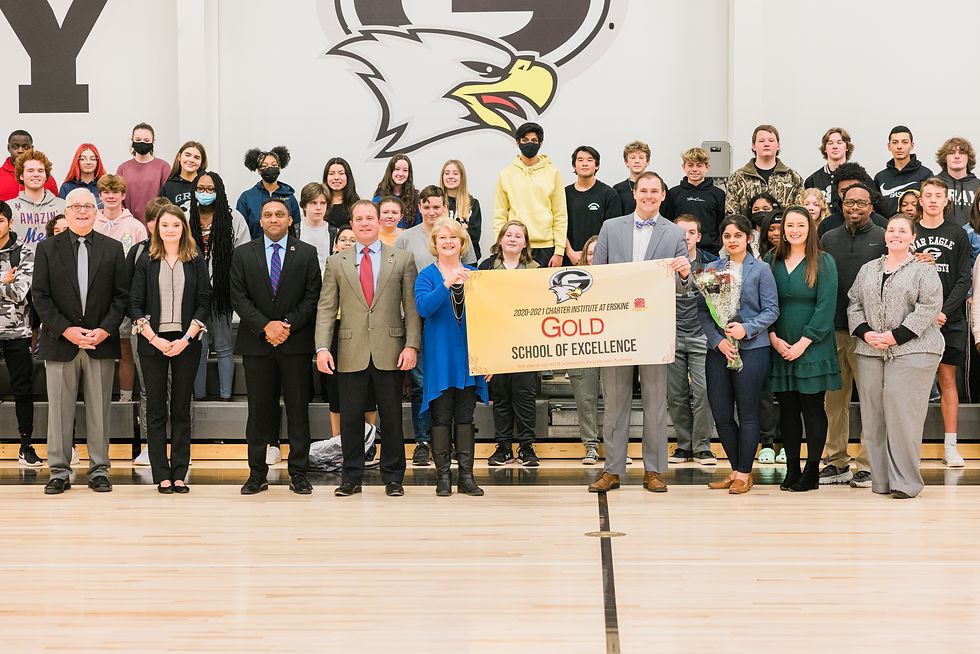 Gray being awarded with school of excellence banner