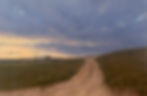 Dirt road leading to sunset over grassy hills