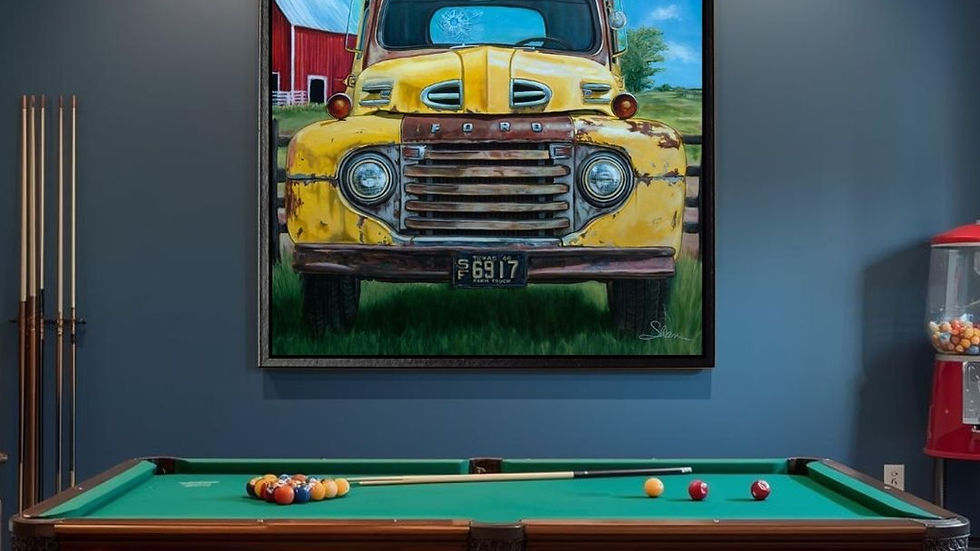 Painting of a yellow truck by Shan Fannin in a game room with blue walls and a billiards table