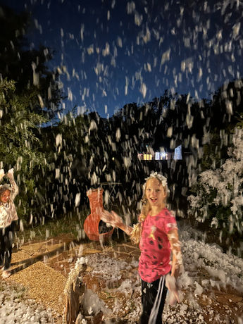 Little girl playing in snow foam in Plano, TX