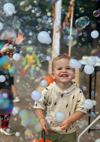 Little boy playing in haze bubbles in Dallas, TX