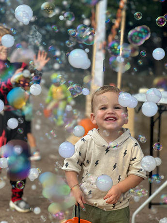 Little boy playing in haze bubbles in Dallas, TX