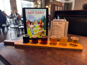 Amy Daws Nine Month Contract book paired with a flight of beer