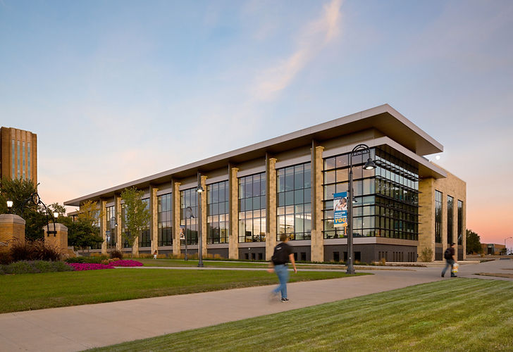 Large modern university building with students walking