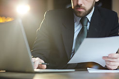 bearded-businessman-working-with-documents-in-office (1).jpg