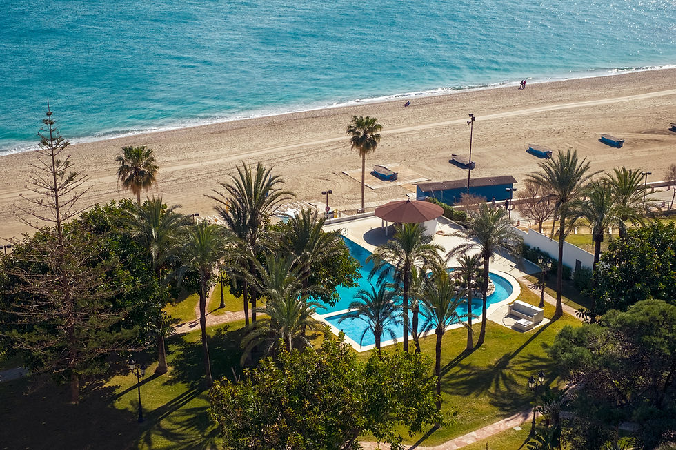 swimming-pool-with-palm-trees-by-sea-beach.jpg