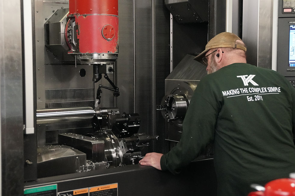man operating cnc machine, demonstrating cnc machining capabilities