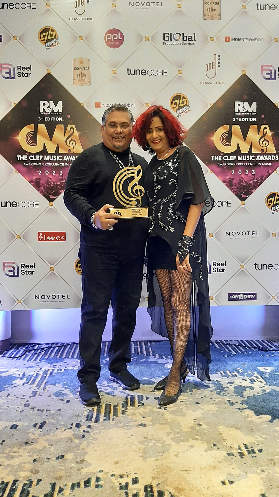 Portrait of Glenn Valles, the international award-winning songwriter, holding a Clef Music Award, representing his significant contributions to the music iidustry with hits like "The Warden."