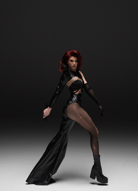 Olesia Glants performing live in Dubai with dramatic lighting and ethereal energy