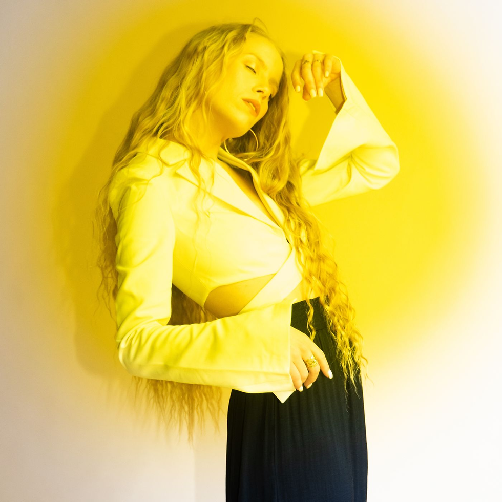 Promotional shot of Silja Rós, the Reykjavík-based artist behind the new single 'Honey...', poised in a modern, artistic setting.