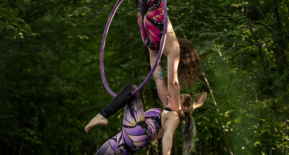 Jamie Normand and partner perform duo aerial hoop in a park