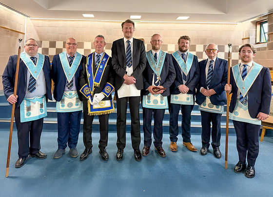 The Worshipful Master, W.Bro. Andy Moore accompanied by Bro. Stephen Bell, after receiving