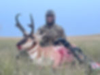 Archer stalking pronghorn antelope in South Dakota grasslands
