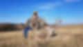 Hunter with rifle and whitetail buck from South Dakota tribal land hunt
