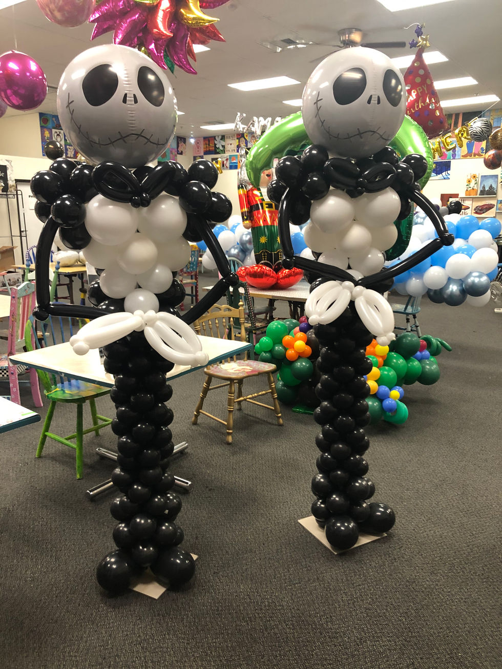 two jack skellington balloons are standing next to each other