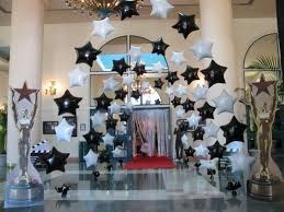 a room filled with lots of balloons in the shape of stars .
