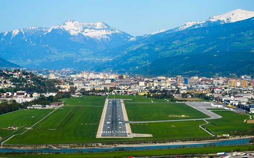 Innsbruck Airport runway surrounded by alpine terrain used in challenging flight simulator approaches