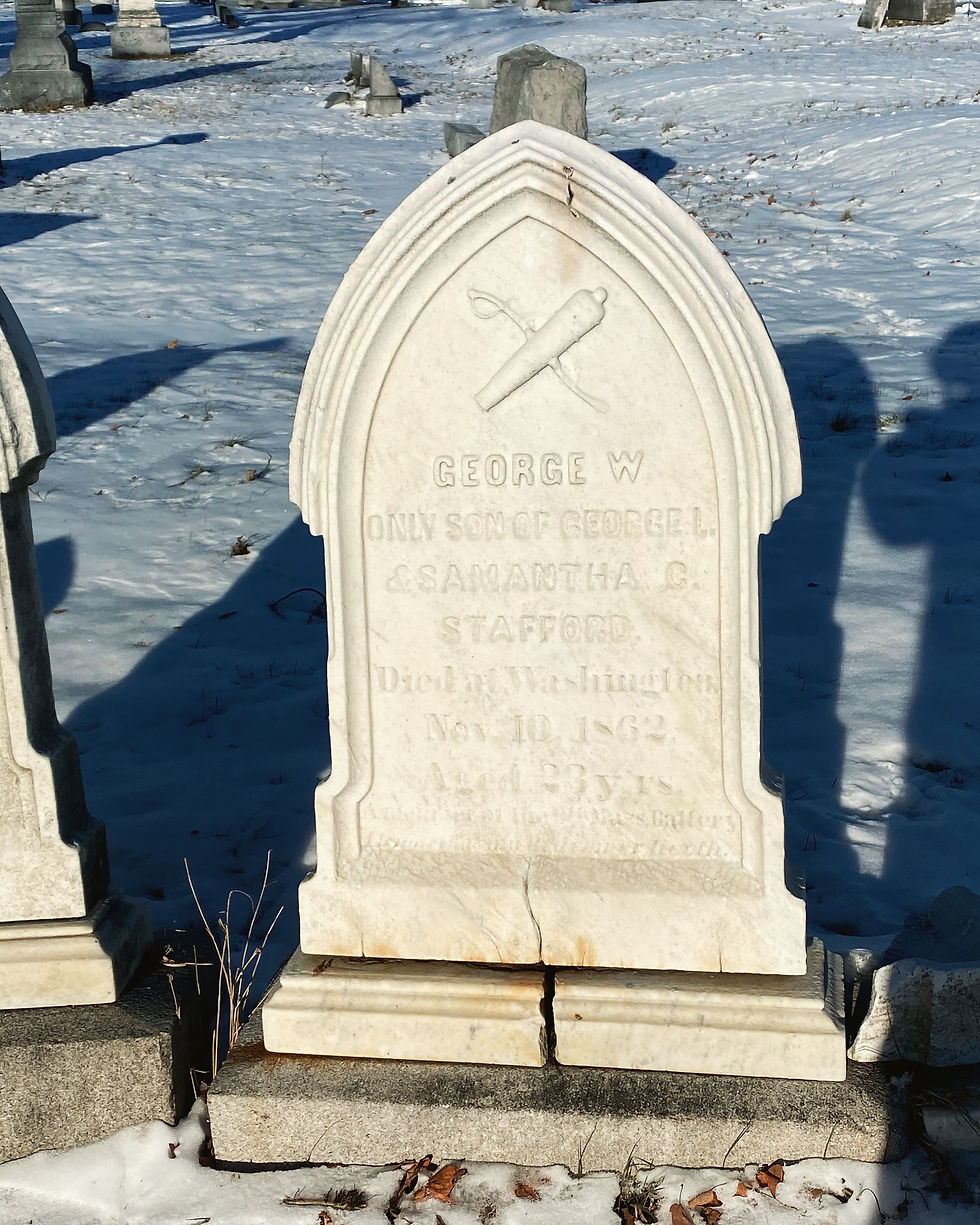 Marble gravestone of George W. Stafford with saber and cannon at the top