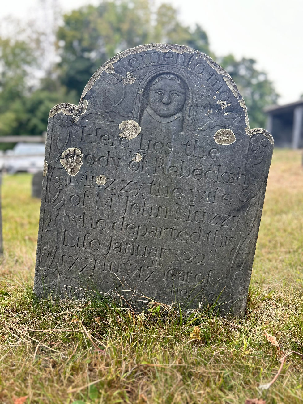 Portrait detail of the gravestone of Rebeckah Muzzy